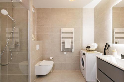 a bathroom with a toilet and a sink and a shower at Féeries Provençales YourHostHelper in Grimaud