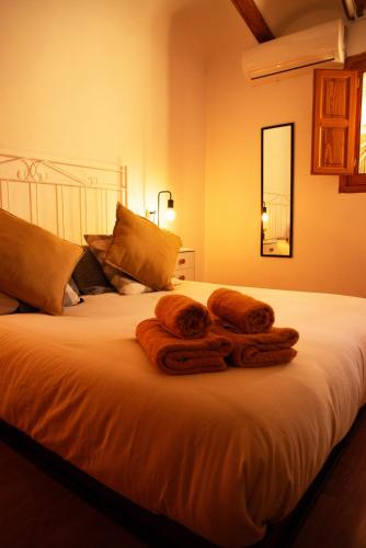 a bed with two towels on top of it at Castle House Xativa in Xàtiva