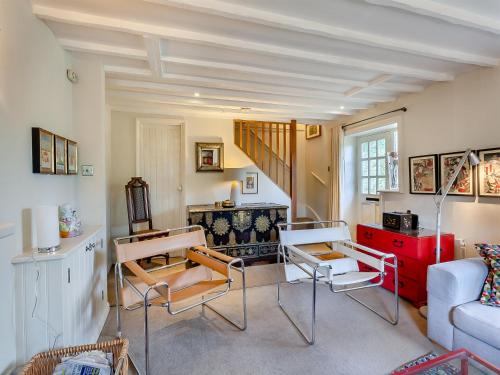 a living room with a white couch and chairs at Pensway in Burpham