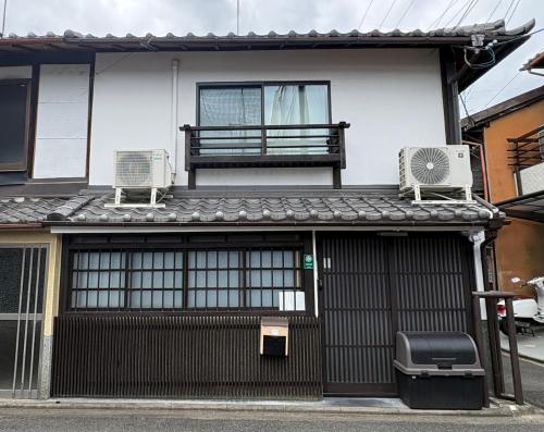 a house with two chairs and a bench on top of it at INN Plus General Castle Nijo in Kyoto