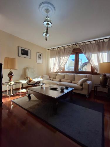 a living room with a couch and a coffee table at As Pitas 1 in Tapia de Casariego