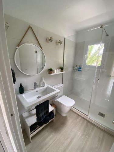 a bathroom with a sink and a toilet and a mirror at M&B Blue Beach in Son Xoriguer