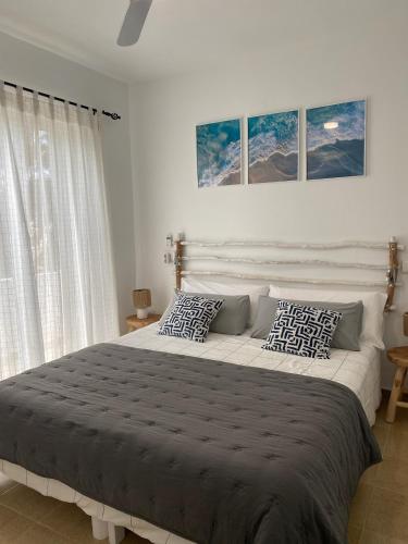 a bedroom with a large bed with two pillows at M&B Blue Beach in Son Xoriguer