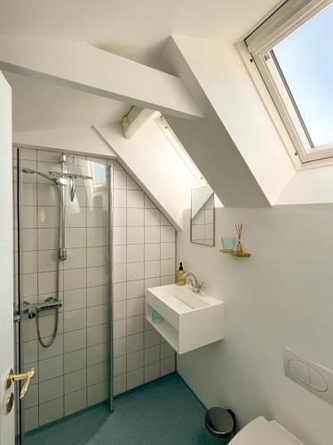 a bathroom with a sink and a shower at Hotel Strandgaarden in Vesterø Havn