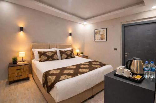 a bedroom with a large bed and a black door at Whitestone Hotel in Nevşehir