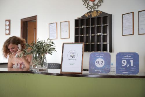 a little girl sitting on a counter with a display at Yalis Hotel in Votsi