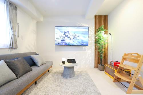 a living room with a couch and a table at Urna Sands Hotel in Tokyo
