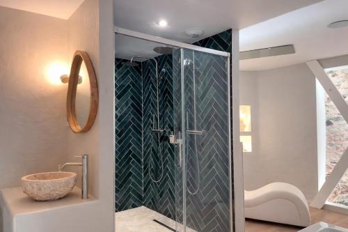 a bathroom with a glass shower with a sink at Les Jolies Nuits - À la folie, Loft & Spa in Montrevault