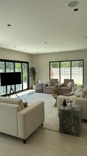 a large living room with couches and a piano at Malath Farm in Al Rahba