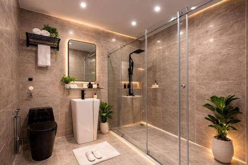 a bathroom with a shower and a sink at HELLO VILLA & SPA in Hue