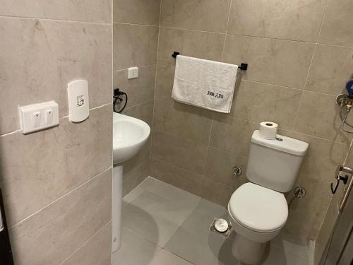 a bathroom with a white toilet and a sink at Florenza Resort- Hurghada in Hurghada