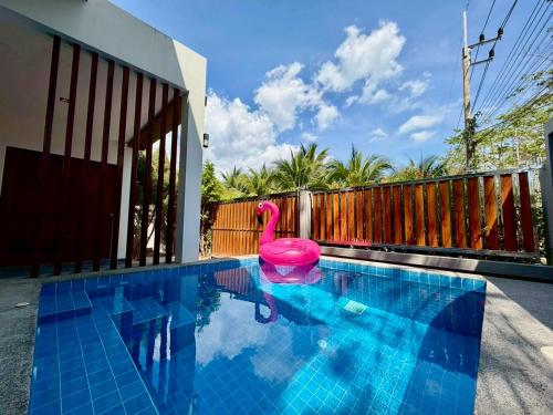 a swimming pool with a pink swan in the water at Bestest Pool Villa in Krabi