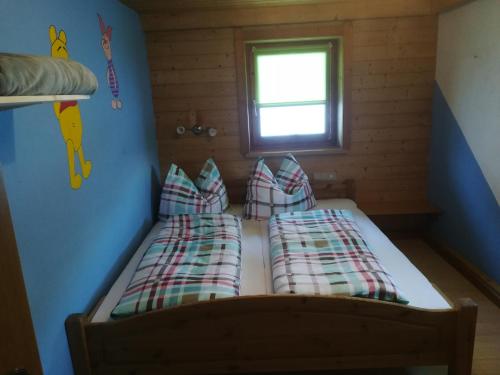 two beds in a small room with a window at Bauernhaus Fankhauser in Hippach