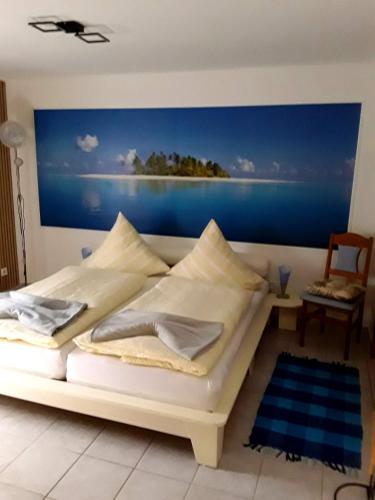 a bedroom with a bed with a painting on the wall at Pension Müller in Barweiler