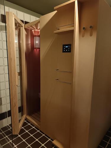 a bathroom with a walk in shower next to a toilet at Dolomitiloungebelluno Mountain Stay in Belluno