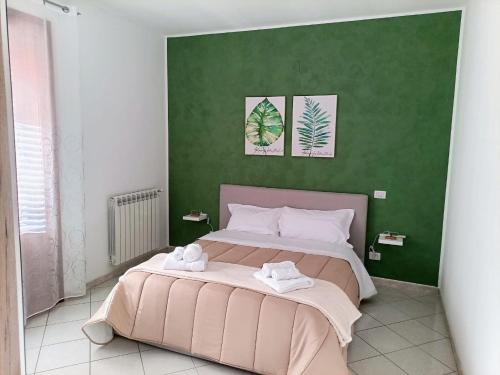 a bedroom with a large bed with two towels on it at La Capaciota in Capaci
