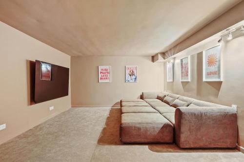 a living room with a couch and a flat screen tv at French house in Paris