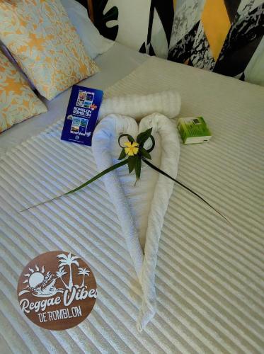 a towel in the shape of a heart on a bed at Green Sea Turtle in Romblon