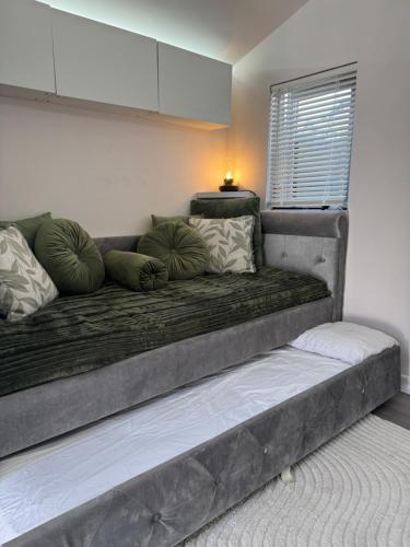 a couch with pillows on it in a room at Maple Gem in Birmingham