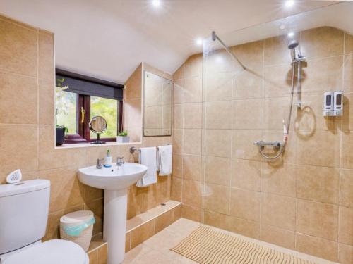 a bathroom with a sink and a toilet and a shower at Y Bwythyn - Lovely cottage in village of Spittal in Haverfordwest
