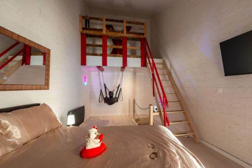 a room with a bed with a santa clause toy on it at love escape "Love Room" in Saint-Paul-Trois-Châteaux