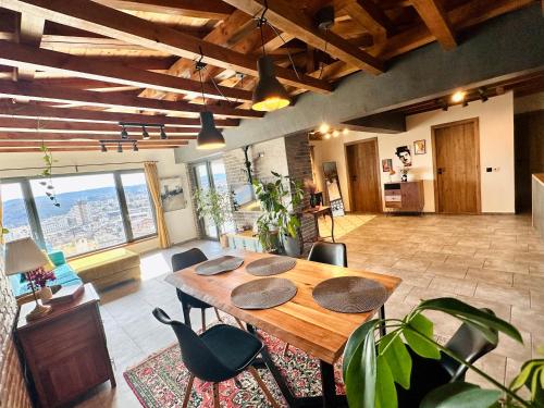 a large room with a wooden table and chairs at Studio54 Stunning View plus Free Parking in Veliko Tŭrnovo