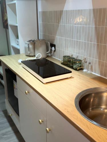 a kitchen counter with a sink and a mixer at Maple Gem in Birmingham