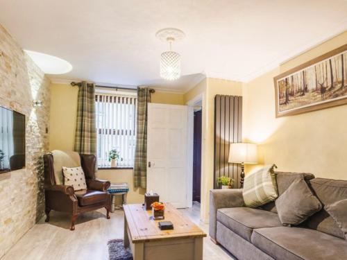 a living room with a couch and a table at Plas Bach in Haverfordwest
