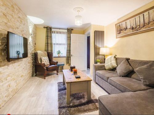 a living room with a couch and a table at Plas Bach in Haverfordwest
