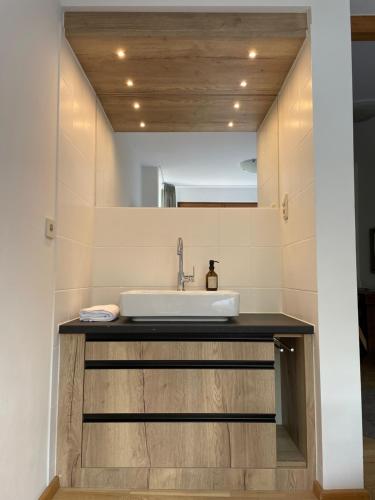 a bathroom with a sink and a mirror at Hotel Askania 1927 in Bad Wiessee