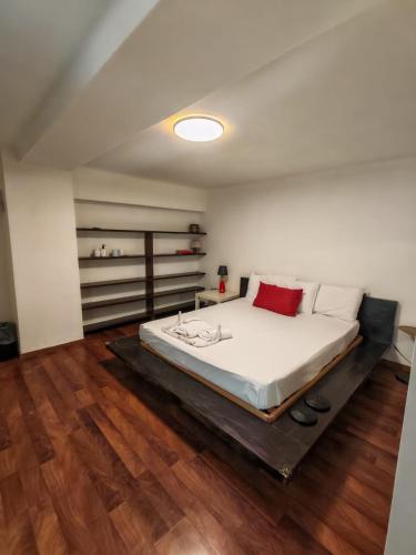 a large bed in a room with wooden floors at L'Amplesso xxx in Bari
