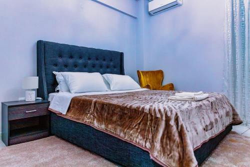 a bedroom with a large bed with a black headboard at Messolonghi Holy City in Missolonghi