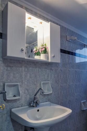 a bathroom with a sink and a mirror at Messolonghi Holy City in Missolonghi