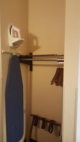 a bathroom with a blue surfboard on a shelf at The Rutledge Inn in Luverne