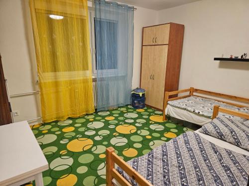 a bedroom with two beds and a green and yellow carpet at Olé in Zlatá Olešnice