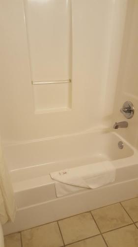 a white bath tub with a towel sitting on it at The Rutledge Inn in Luverne