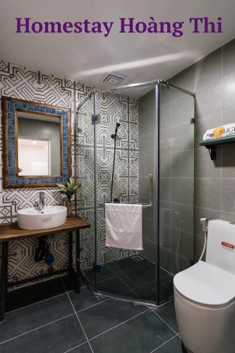 a bathroom with a shower and a toilet and a sink at Homestay Hoàng Thi in Phan Thiet