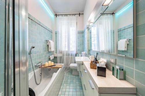 a bathroom with a tub and a sink and a toilet at Cavour Suite Luxury in Bologna