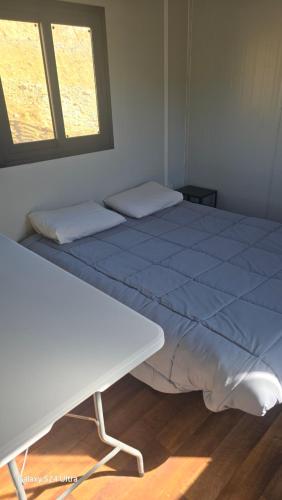 a large bed in a room with a window at Anastasi Tiny Homes- Mountain Views, Garden & Terrace, Pet Friendly in Kakopetria