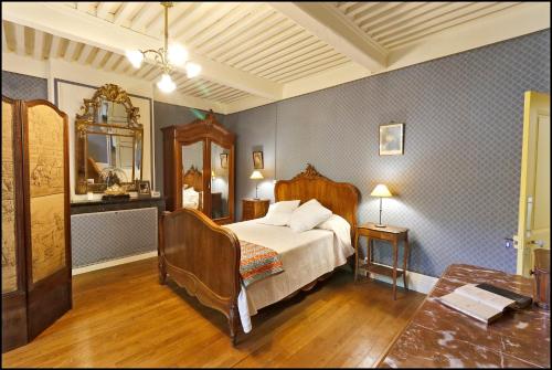 a bedroom with a bed and a mirror at Maison Emile Teissier in Vébron