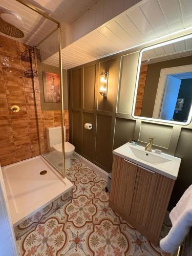 a bathroom with a sink and a shower and a toilet at The Covenanter Hotel in Falkland