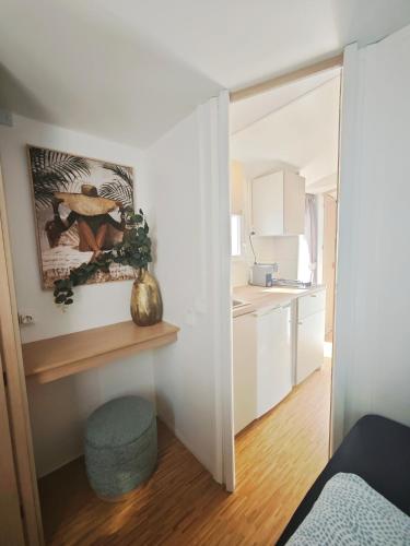 a white room with a kitchen and a room with a door at Casa Amarela-Tiny House with fantastic view-pool and close to the beaches in Silves