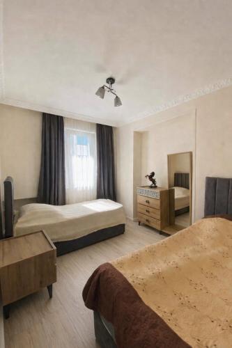 a hotel room with two beds and a dresser at Welcome2 in Kobuleti