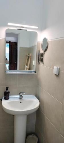 a bathroom with a sink and a mirror at Casa dos Avós Palma - Alcoutim in Alcoutim
