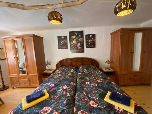 a bedroom with a bed with two pillows on it at Chata Štefička in Josefŭv Dŭl