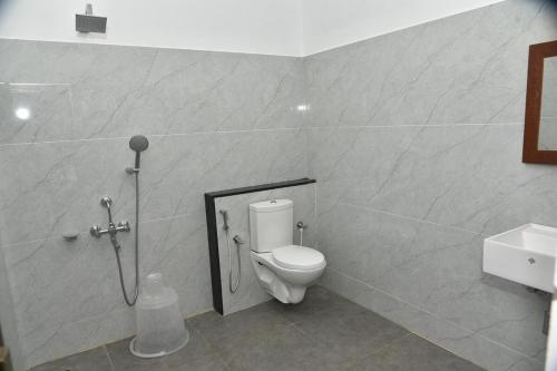 a bathroom with a toilet and a sink at Shans Valley in Kotagiri