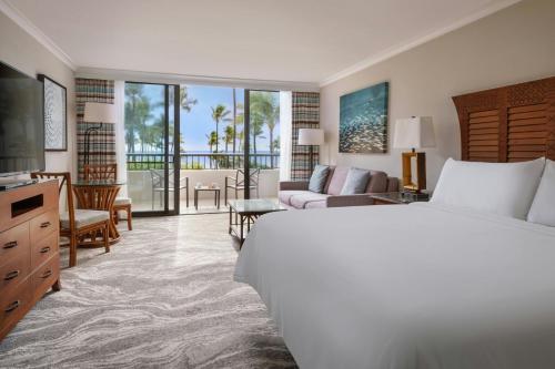 a hotel room with a bed and a living room at Marriott's Maui Ocean Club - Molokai, Maui & Lanai Towers in Lahaina