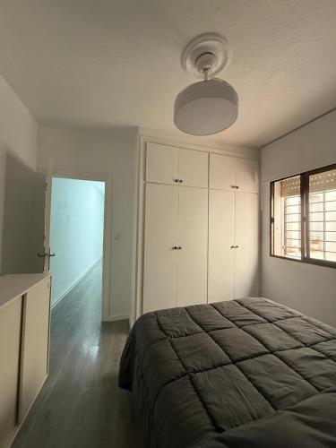 a bedroom with a large bed and a window at LUZ DEL MAR Almuñécar Centro Playa in Almuñécar