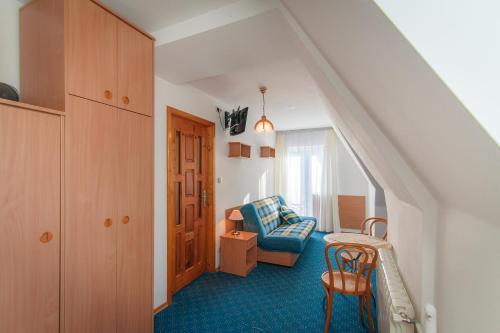 a living room with a couch and a chair at Nasz Dom in Kościelisko