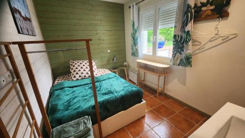 a bedroom with a bed in a room with a window at L'Escale - private bed, shower room & kitchen in Blagnac